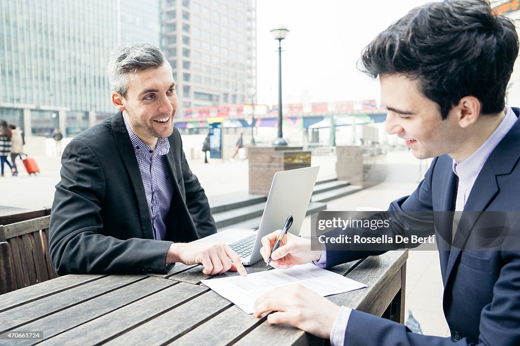 Business Meeting Outdoors, Businessmen Discussing A Contract