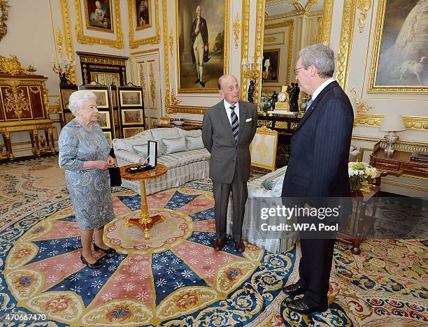 Queen Elizabeth II talks with the Australian High Commissioner Alexander Downer as she prepares to present the Prince Philip, Duke of Edinburgh with...