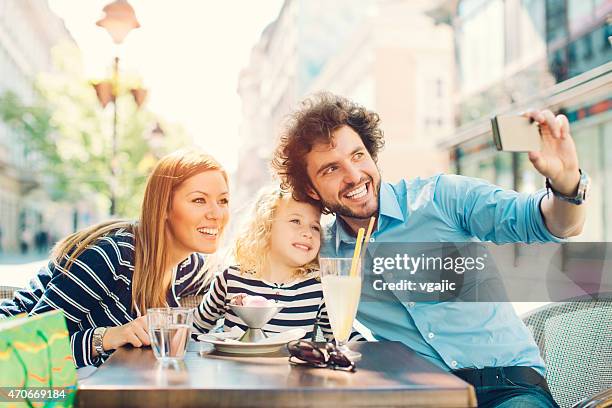 cheerful family with little girl making selfie. - children restaurant stockfoto's en -beelden