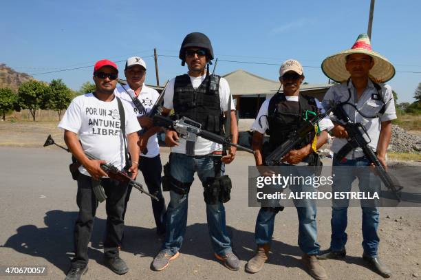 Members of the so-called self-defense groups pose for a picture at Antunez community, Michoacan state, Mexico, on February 15, 2014. Next February 24...