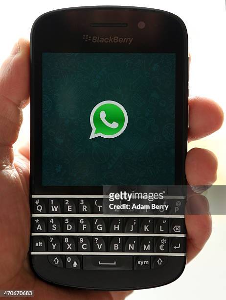 In this photo ilustration, the WhatsApp startup screen is seen on a Blackberry Q10 mobile phone on February 20, 2014 in Berlin, Germany. The social...