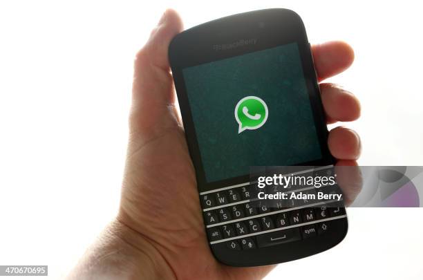 In this photo ilustration, the WhatsApp startup screen is seen on a Blackberry Q10 mobile phone on February 20, 2014 in Berlin, Germany. The social...