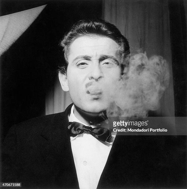 "Italian singer-songwriter, actor and director Domenico Modugno smoking. Italy, 1950s "