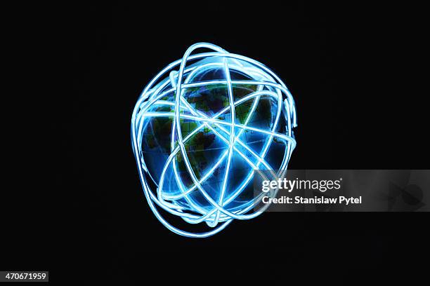 planet earth surrounded by glowing lines - virtualitytrend stock pictures, royalty-free photos & images