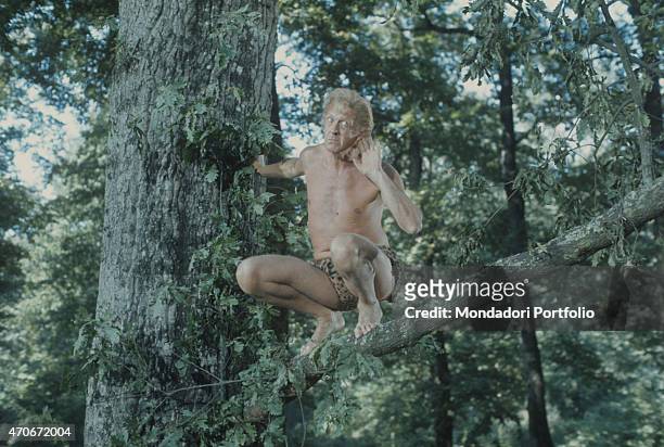 "Italian actor and TV host Raimondo Vianello dressed as Tarzan acting in the final theme of the TV variety show Noi no. Italy, 1977 "