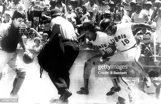 Lyman Bostock of the California Angels and teammate Ron Jackson protest after umpire Terry Cooney called Bostock out as catcher Jim Sundberg of the...