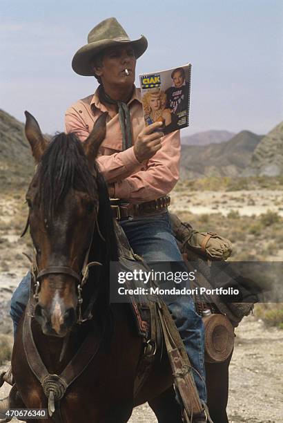 "Italian actor Giuliano Gemma reading the magazine Ciak on the set of the film Tex and the Lord of the Deep. Italy, 1985 "