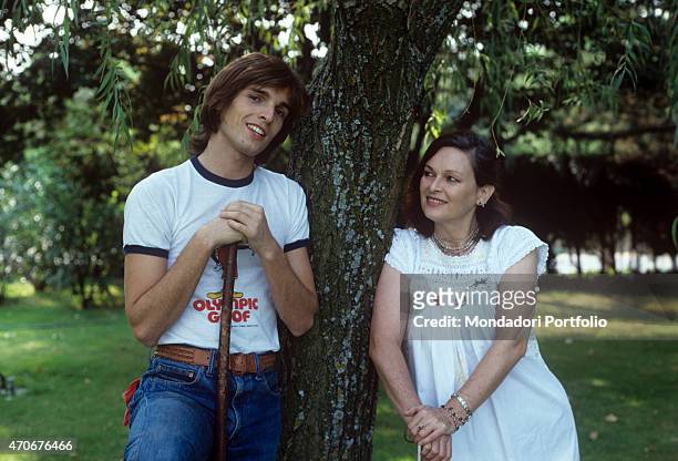 Spanish-Italian actor and singer Miguel Bosé smiling beside his mother and Italian actress Lucia Bos . 1978