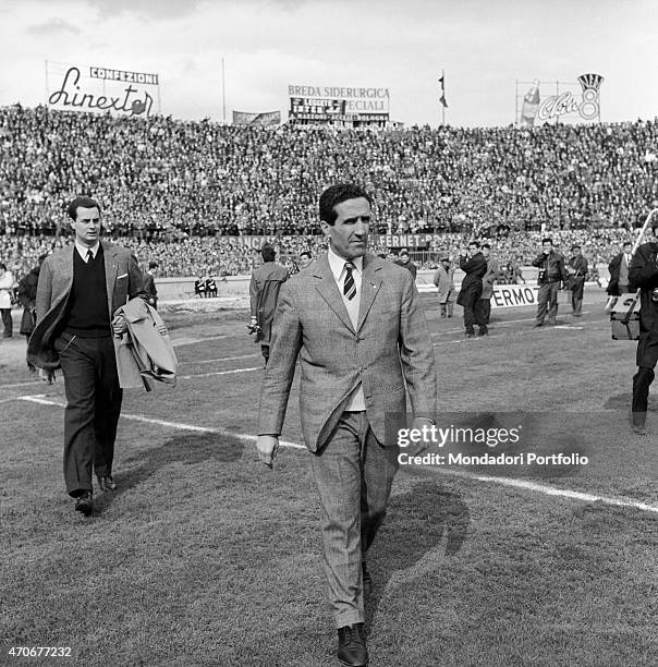 "Argentinian-born French football player and coach Helenio Herrera walking on the football ground after the match between Italian football teams...