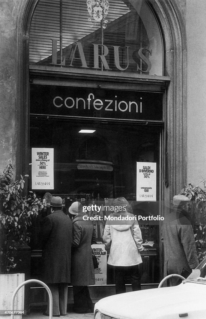 People looking at Larusmiani's shop window