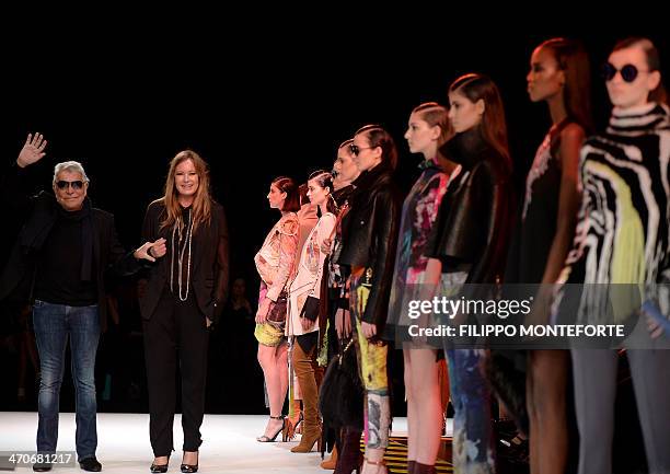 Italian designer Roberto Cavalli and his wife Eva acknowledge the crowd after their fashion show as part of the Milan's Women's fashion week...