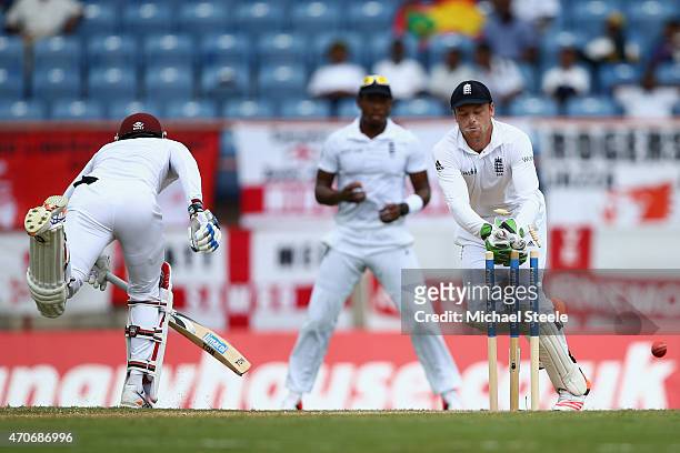 Jos Buttler the wicketkeeper of England fails to gather the ball and misses a opportunity to run out Denesh Ramdin of West Indies during day two of...