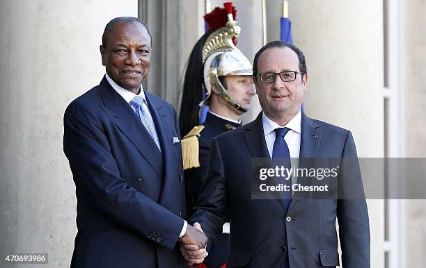 French President Francois Hollande welcomes Guinean President Alpha Conde prior to a meeting at the Elysee Palace on April 22, 2015 in Paris, France.