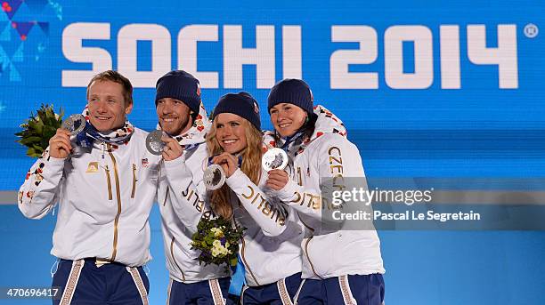 Silver medalists Ondrej Moravec, Jaroslav Soukup, Gabriela Soukalova and Veronika Vitkova of the Czech Republic celebrate during the medal ceremony...