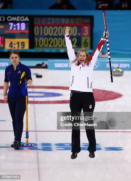 Jennifer Jones of Canada celebrates after placing a stone to win the gold medal while Maria Wennerstroem looks on during the Gold medal match between...