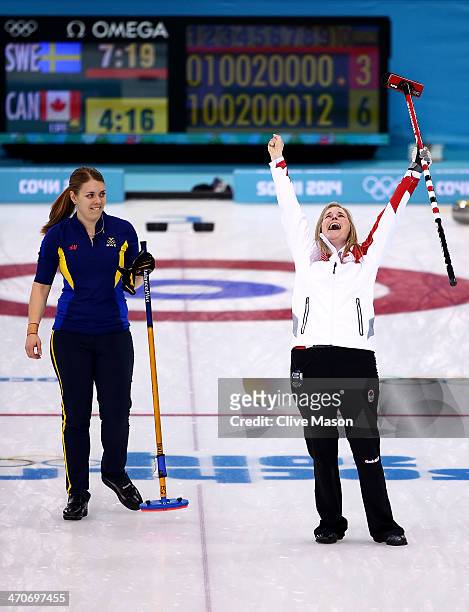Jennifer Jones of Canada celebrates after placing a stone to win the gold medal while Maria Wennerstroem looks on during the Gold medal match between...