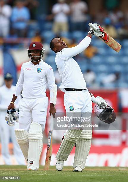 Marlon Samuels of West Indies celebrates reaching his century alongside Denesh Ramdin during day two of the 2nd Test match between West Indies and...