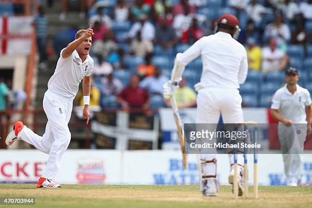 Stuart Broad of England celebrates taking the wicket of Denesh Ramdin of West Indies during day two of the 2nd Test match between West Indies and...