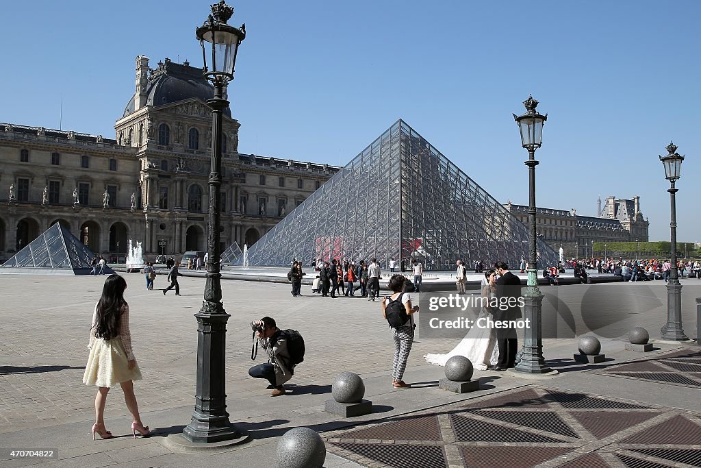 Tourists Visit The Pyramid of the Louvre