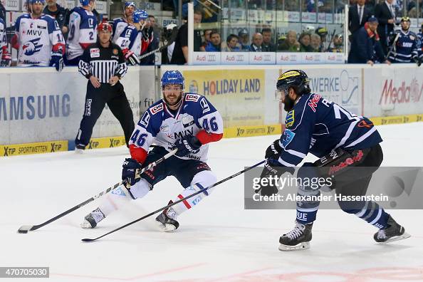 Jonathan Rheault of Mannheim battles for the puck with Dustin Friesen ...