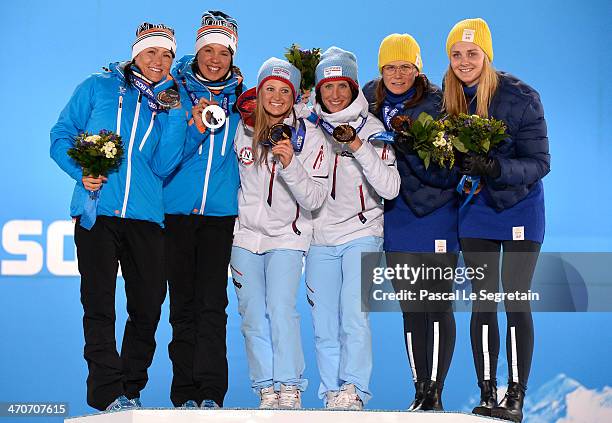 Silver medalists Aino-Kaisa Saarinen and Kerttu Niskanen of Finland, gold medalists Ingvild Flugstad Oestberg and Marit Bjoergen of Norway and bronze...