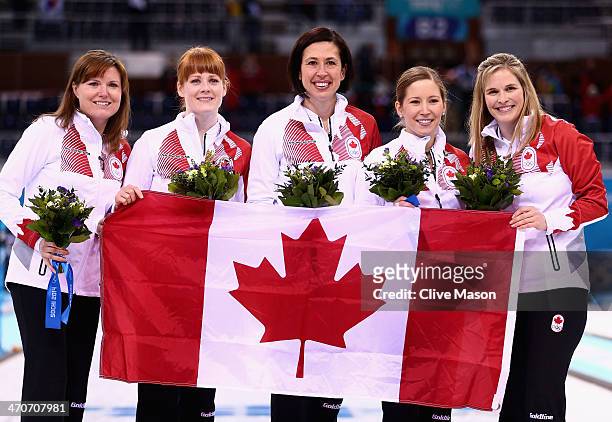 Gold medalists Jennifer Jones , Kaitlyn Lawes , Jill Officer , Dawn McEwen and Kirsten Wall of Canada celebrate during the flower ceremony for the...