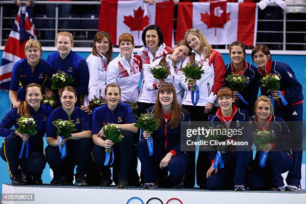 Silver medalists of Sweden, gold medallists of Canada and bronze medalists of Great Britain celebrate during the flower ceremony for the Gold medal...