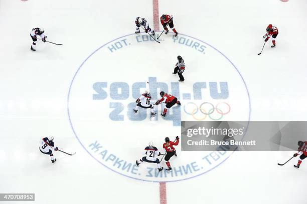 Kelli Stack of the United States and Hayley Wickenheiser of Canada face off during the Ice Hockey Women's Gold Medal Game on day 13 of the Sochi 2014...