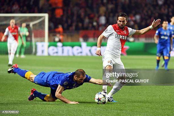 Juventus' defender Giorgio Chiellini commits a foul by touching the ball with the hand as Monaco's Portuguese midfielder Joao Moutinho looks on...