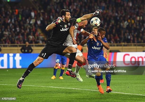 Gianluigi Buffon of Juventus punches clear as Patrice Evra of Juventus takes evasive action during the UEFA Champions League quarter-final second leg...