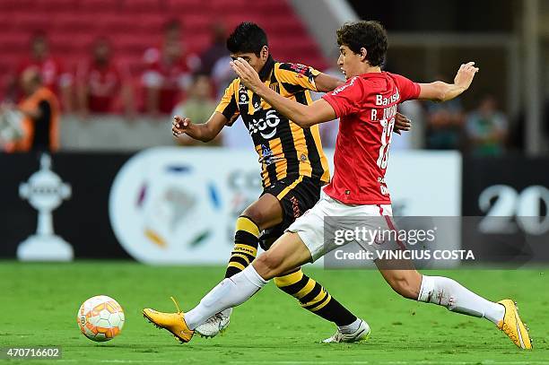 Raul Castro of Bolivia's The Strongest vies for the ball with Rodrigo Dourado of Brazil's Internacional, during the Copa Libertadores 2015 football...