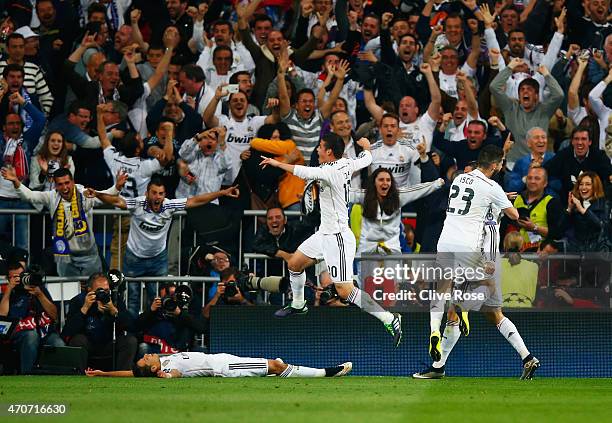 Javier Hernandez of Real Madrid CF celebrates with fans and team mates as he scores their first goal during the UEFA Champions League quarter-final...