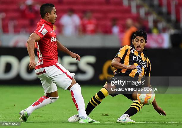 Raul Castro of Bolivia's The Strongest vies for the ball with Jorge Henrique of Brazil's Internacional, during the Copa Libertadores 2015 football...