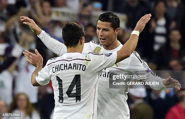 Real Madrid's Portuguese forward Cristiano Ronaldo congratulates teammate Real Madrid's Mexican forward Javier Hernandez after the UEFA Champions...