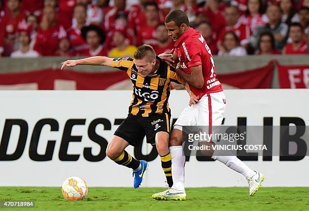 Chumacero of Bolivia's The Strongest struggles for the ball with Ernando, of Brazil's Internacional, during the Copa Libertadores 2015 football match...