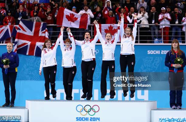 Gold medalists Jennifer Jones , Kaitlyn Lawes , Jill Officer , Dawn McEwen and Kirsten Wall of Canada celebrate during the flower ceremony for the...