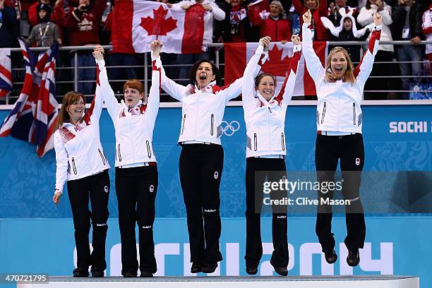 Gold medalists Jennifer Jones , Kaitlyn Lawes , Jill Officer , Dawn McEwen and Kirsten Wall of Canada celebrate during the flower ceremony for the...