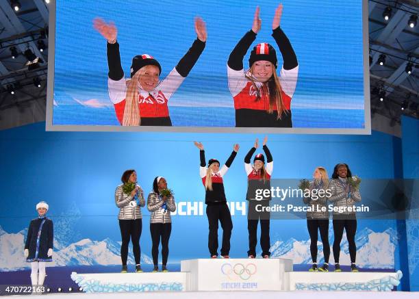 Silver medalists Elana Meyers and Lauryn Williams of the United States team 1, gold medalists Kaillie Humphries and Heather Moyse of Canada team 1...