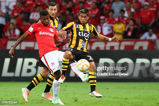 Geferson of Internacional battles for the ball against Nelvin Soliz of The Strongest during match between Internacional and The Strongest as part of...