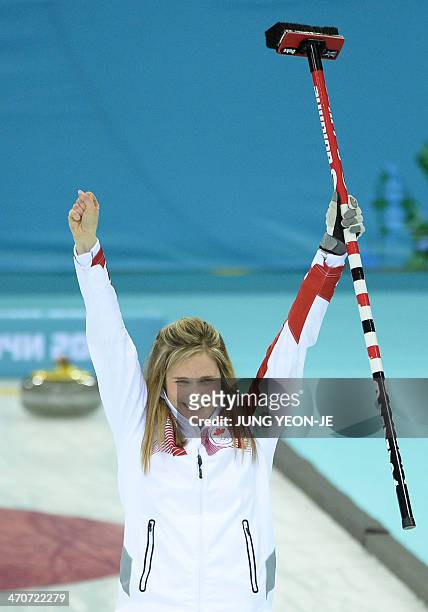Canada's Jennifer Jones celebrates winning gold in the Women's Curling Flower Ceremony at the Ice Cube Curling Center during the Sochi Winter...