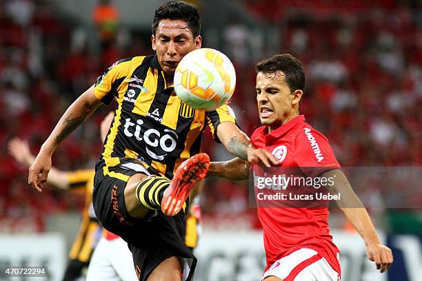 Nilmar of Internacional battles for the ball against Walter Veizaga of The Strongest during match between Internacional and The Strongest as part of...