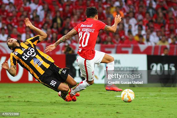 Charles Aranguiz of Internacional battles for the ball against Walter Veizaga of The Strongest during match between Internacional and The Strongest...