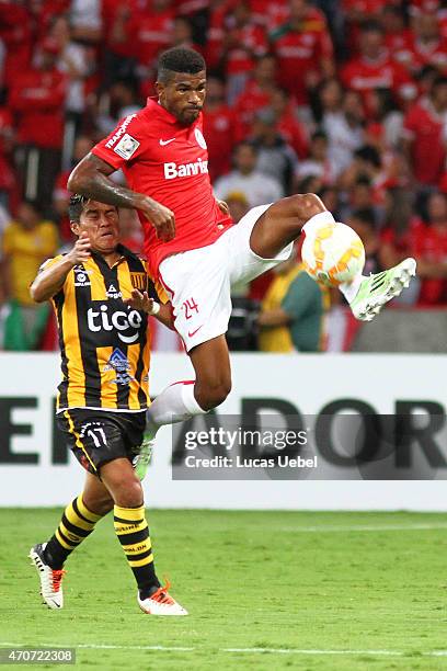 Geferson of Internacional battles for the ball against Nelvin Soliz of The Strongest during match between Internacional and The Strongest as part of...