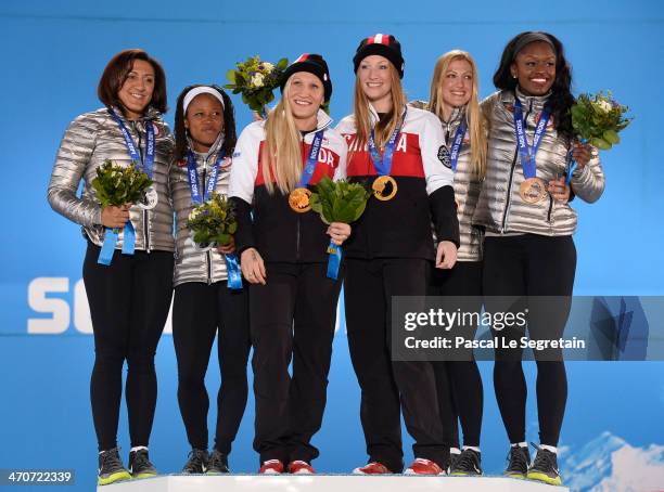 Silver medalists Elana Meyers and Lauryn Williams of the United States team 1, gold medalists Kaillie Humphries and Heather Moyse of Canada team 1...