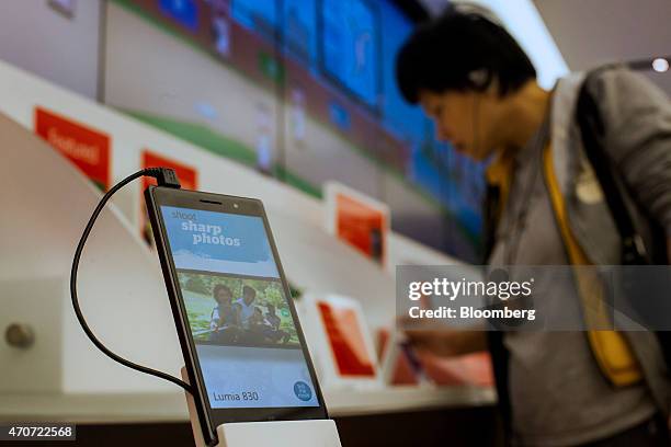 Microsoft Corp. Windows phones is displayed as a customer shops at the company's store in Bellevue, Washington, U.S., on Tuesday, April 21, 2015....