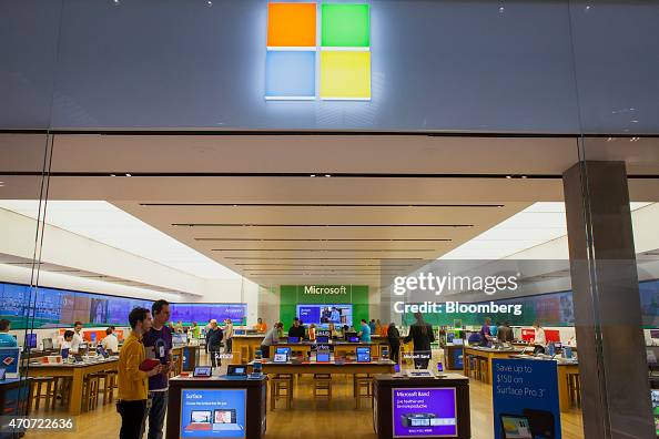 Sales associates wait to greet customers at a Microsoft Corp. store ...