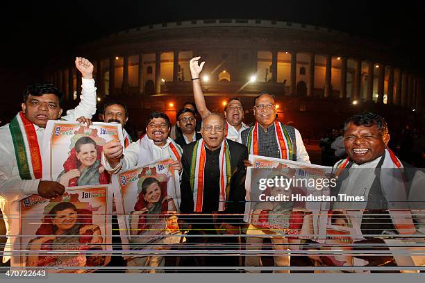 Minister of Science and Technology Jaipal Reddy pose with pro-Telangana Congress leaders who are holding posters of Sonia Gandhi after the passage of...