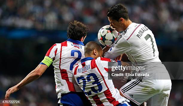 Cristiano Ronaldo of Real Madrid fights for a high ball with Diego Godin and Joao Miranda of Atletico de Madrid during the UEFA Champions League...