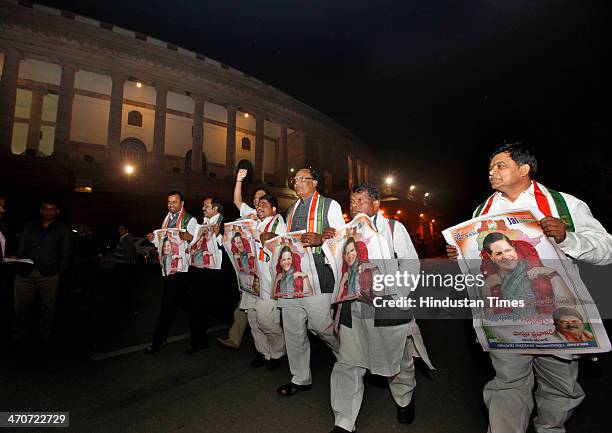 Pro-Telangana Congress leaders hold posters of Sonia Gandhi after the passage of Telangana Bill in the Rajya Sabha, at Parliament House on February...