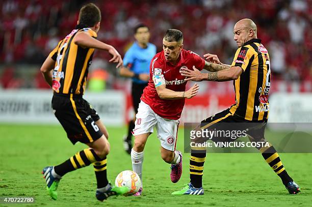 Bolivia's The Strongest German Centurion vies for the ball with Andres D'Alessandro of Brazil's Internacional, during the Copa Libertadores 2015...